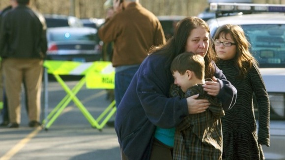 A women comforts a child at the scene