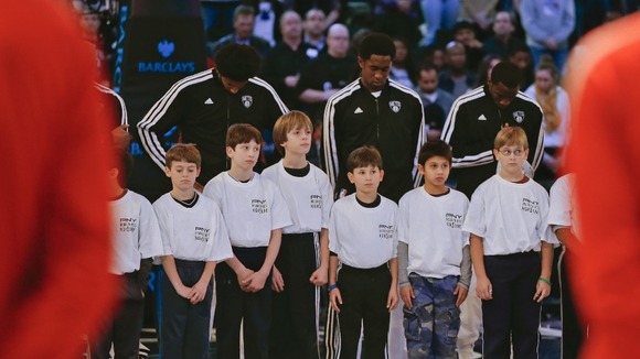 Children join the Brooklyn Nets during a moment of silence for victims of the mass shooting in Newtown, Connecticut