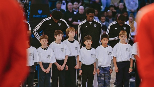 Children join the Brooklyn Nets during a moment of silence for victims of the mass shooting in Newtown, Connecticut
