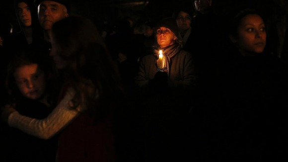 People grieve outside the vigil at the Saint Rose of Lima church in Newtown, Connecticut