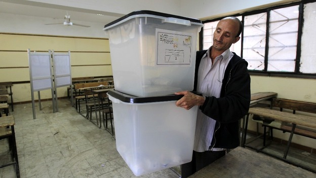 An employee of the constitutional referendum committee prepares a ballot box 