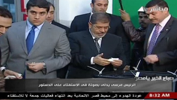 Egyptian President Mohamed Mursi casts his vote in the referendum on the constitution