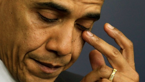President Barack Obama wiping away tears at a press conference on Friday