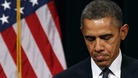 US President Obama looks down as he walks from the rostrum