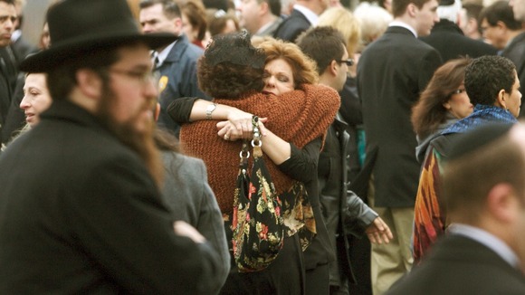 Veronique Pozner is hugged after the funeral services for her son Noah Pozner,