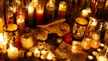 Flowers, candles and stuffed animals are seen at a makeshift memorial in Newtown