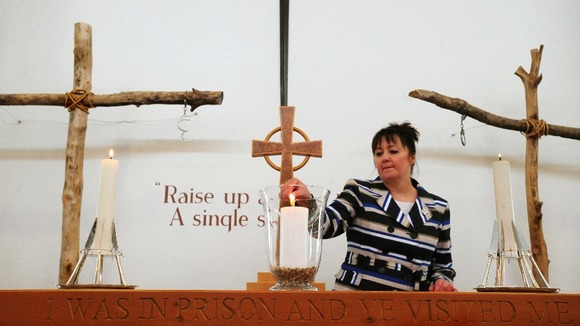 Margaret Allen, widow of Able Seaman Iain Boldy, lighting a candle at the National Memorial Arboretum.