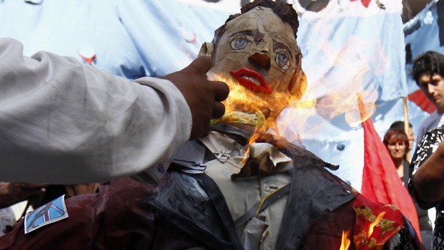 A man sets fire to an effigy depicting Britain's Prince William during a demonstration outside the British embassy in Buenos Aires