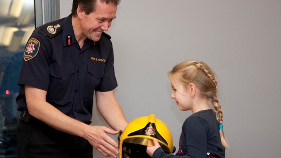 Chief Officer John Bonney presents Alan Bannon's Meritorious Medal for Gallantry to Alan's daughter Abi
