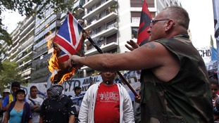Protesters burn the British flag in Buenos Aires.