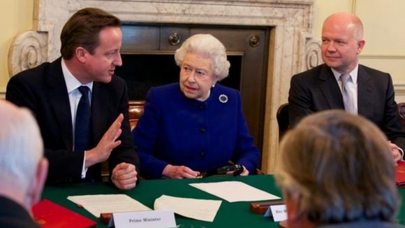 The Queen listens to David Cameron as he addresses Cabinet
