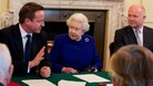 The Queen listens to David Cameron as he addresses Cabinet