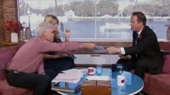 Phillip Schofield passed Prime Minister David Cameron a card
