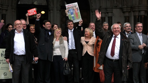Trevor Hicks (front) waves as he comes out of the High Court in London today, with other family members and supporters.