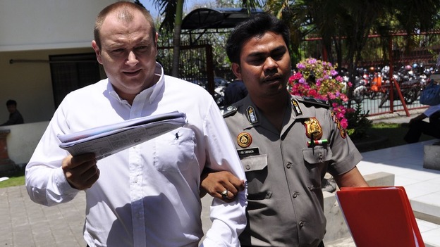 Paul Beales escorted by a policeman as he arrived at his trial earlier this year