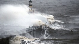 Waves crash into the sea wall at Seaham Harbour