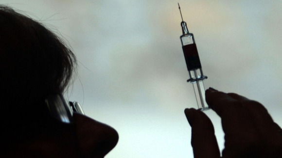 Nurse preparing to give a patient a flu vaccine