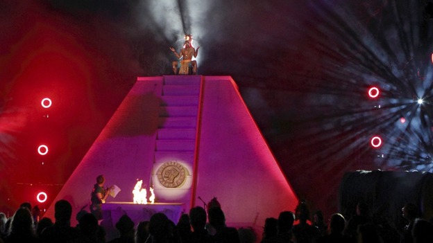 A Mayan priest sits on top of a pyramid at his "End of the World Soiree"
