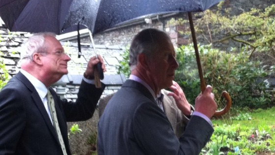 Prince Charles holding umbrella