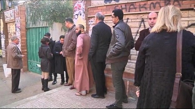 Egyptians queue outside a polling station