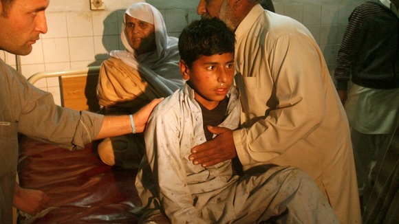 A boy, injured in a bomb blast waits for treatment at a hospital in Peshawar.