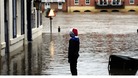 A young Christmas shopper looks at flood water in York city centre as heavy rain continues to cause problems across the UK.