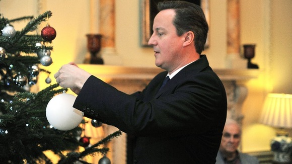 David Cameron seen decorating a Christmas tree at Downing Street