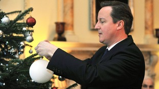 David Cameron seen decorating a Christmas tree at Downing Street
