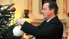 David Cameron seen decorating a Christmas tree at Downing Street