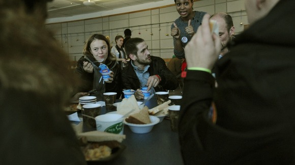 Clients eat breakfast at this year's Crisis at Christmas shelter in London's Docklands.