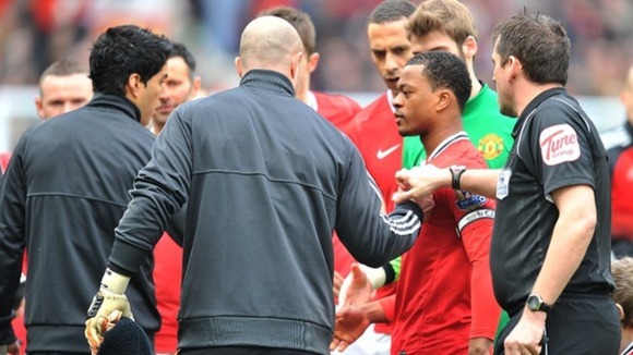 Luis Suarez (L) refuses to shake Patrice Evra's hand