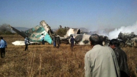 The wreckage of the plane in a rice paddy