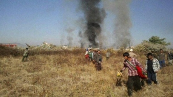 Smoke from the plane is seen in the distance