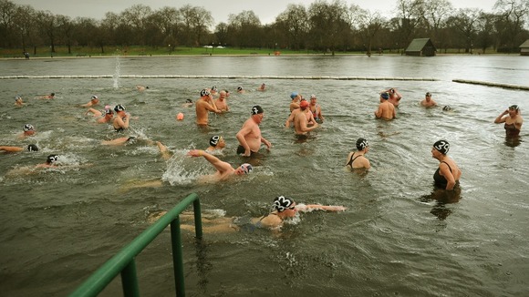 Members of the Peter Pan club cross the finish line during the annual handicapped 100 yard swimming race in the Serpentine