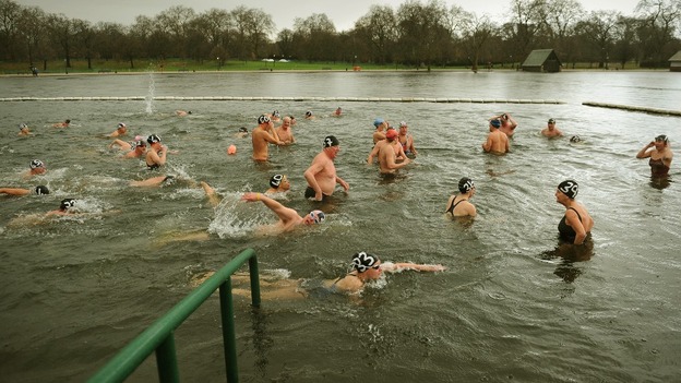 Members of the Peter Pan club cross the finish line during the annual handicapped 100 yard swimming race in the Serpentine