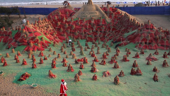 Santa sand sculptures created by artist Pattnaik at beach celebrations in Puri, India