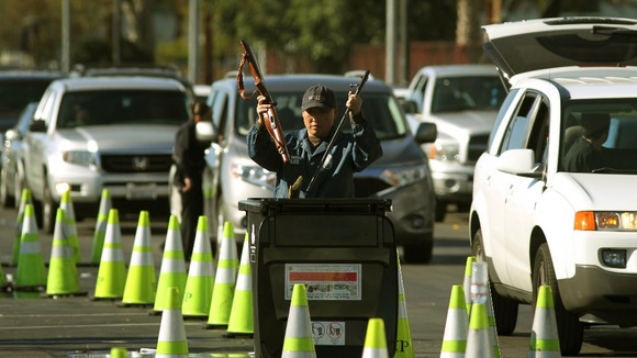 Police officers dispose of the weapons in Los Angeles.