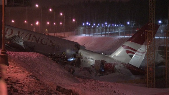 The back end of the plane remains in a ditch at the end of the runway