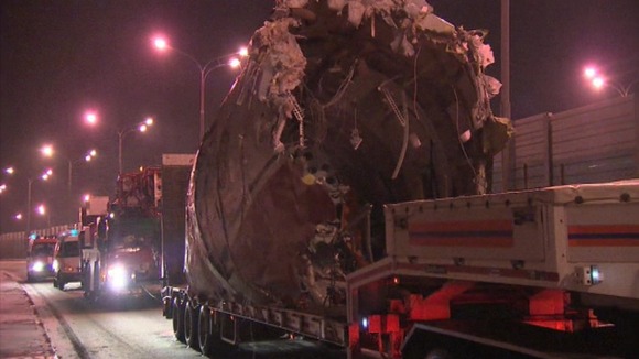 The remains of the plane have been put on to flat bed trucks and removed from the airport