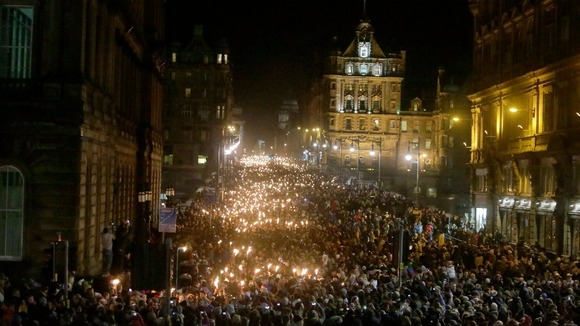 People take part in the torchlight procession through Edinburgh which starts the city's Hogmanay celebrations.