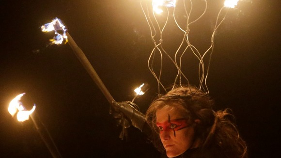 A torchlight procession through Edinburgh begins the city's Hogmanay celebrations. 