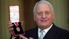 Sir Irvine Patnick receiving his knighthood at Buckingham Palace in 1994