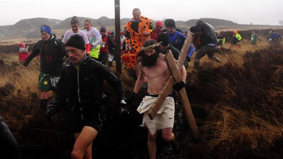 Fancy dress runners make their way through the rain