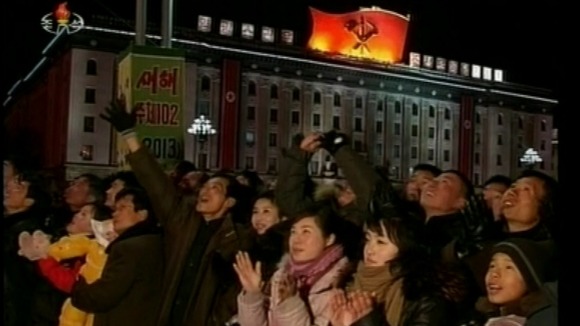 People on the streets of Pyongyang enjoy the fireworks as North Korea celebrates the New Year