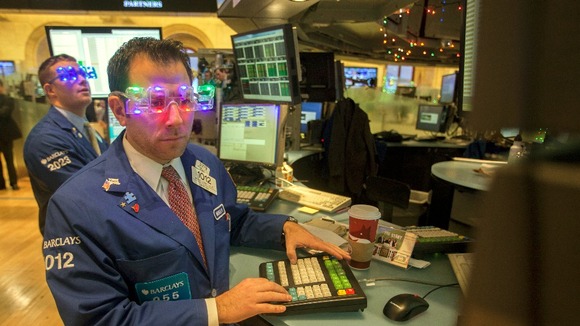 Trader Michael Pistillo wears "2013" glasses celebrating New Year's Eve as he works on the floor of the New York Stock Exchange