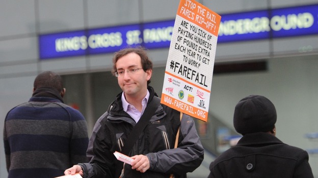 A rail campaigner demonstrates outside King's Cross station in London as regulated fares