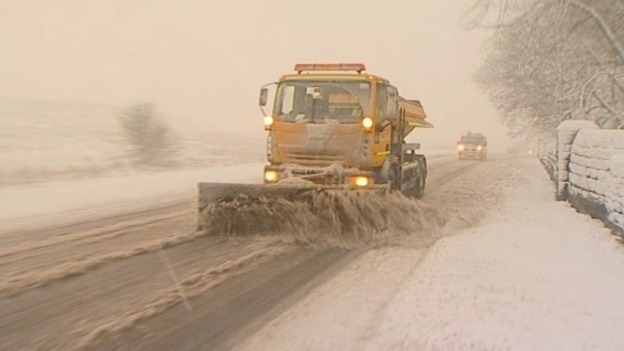 Snow plough clearing road
