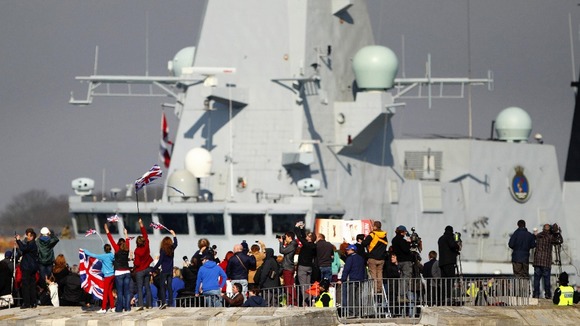 People wave from the Round Tower as the Royal Navy Type 45 Destroyer HMS Dauntless sets sail from Portsmouth.
