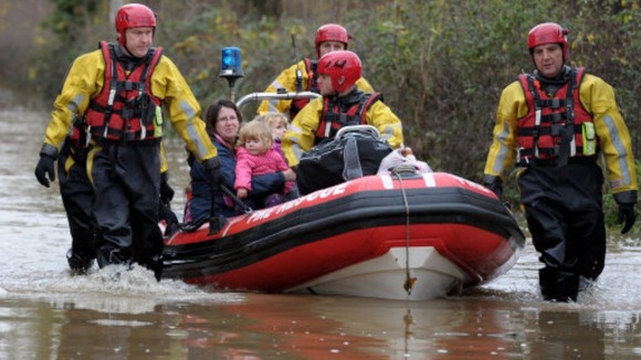 A women and her children are rescued from their house in Gloucester in November.