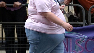An obese woman walking through central London.